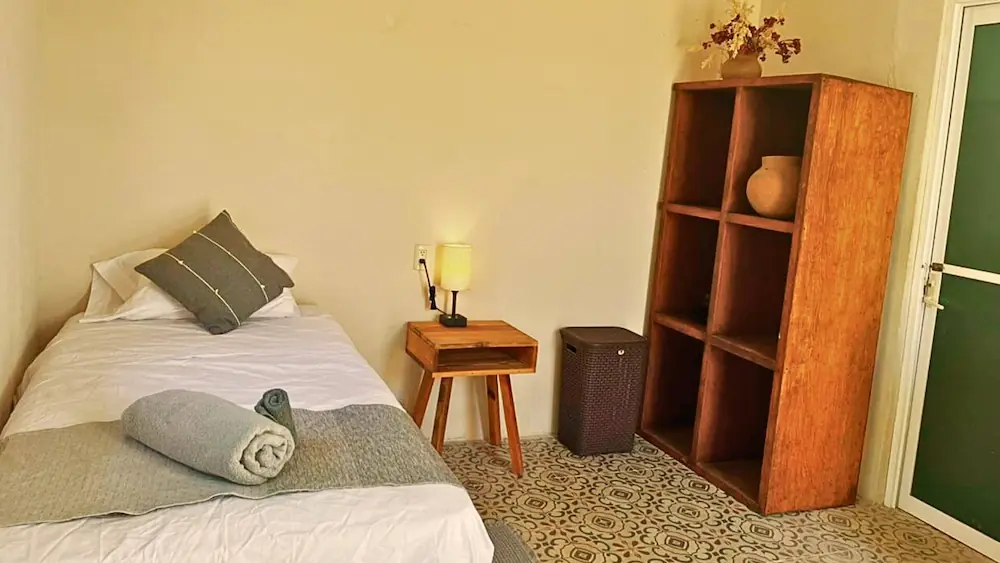 ECO Room interior with bed and dressing area / Interior a Habitación ECO con cama y area de vestidor